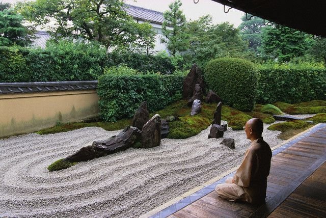 Monk meditating in a Zen Garden